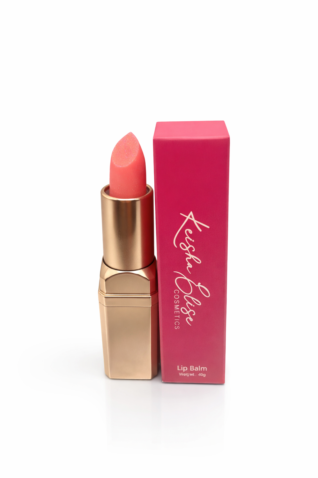 Keisha Elise Cosmetics vegan shimmer lip balm in gold tube displayed next to pink branded packaging on a white background.